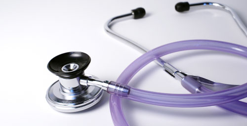 A purple stethoscope on a desk